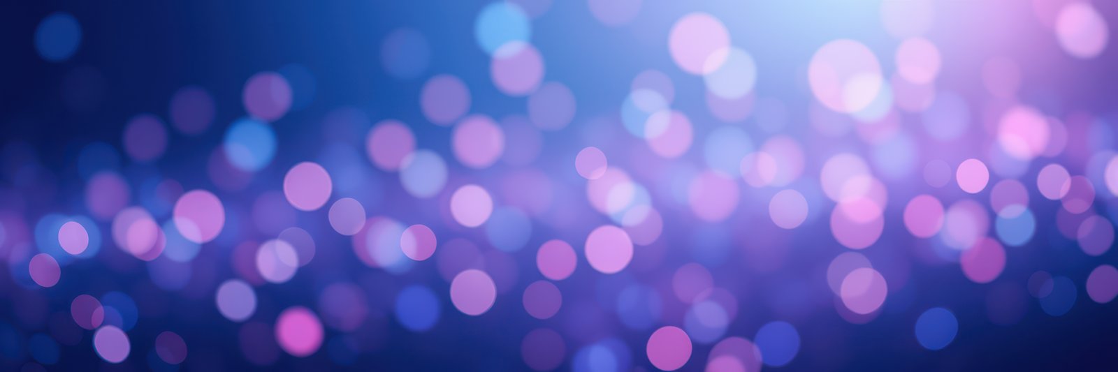 Colorful bokeh lights create a vibrant atmosphere in a nighttime setting, showcasing blurred circles of light